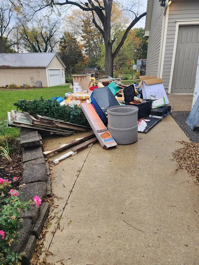 Dumpster being loaded with debris for Roofing Dumpster Rental in Hurst